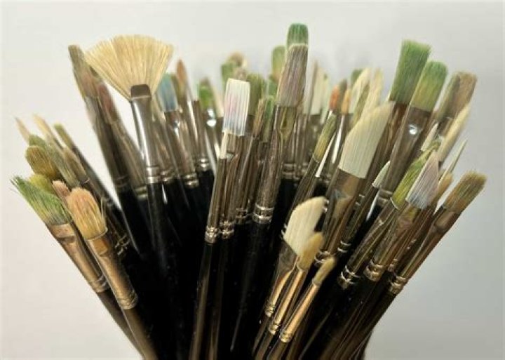 Where should you wash paint brushes?